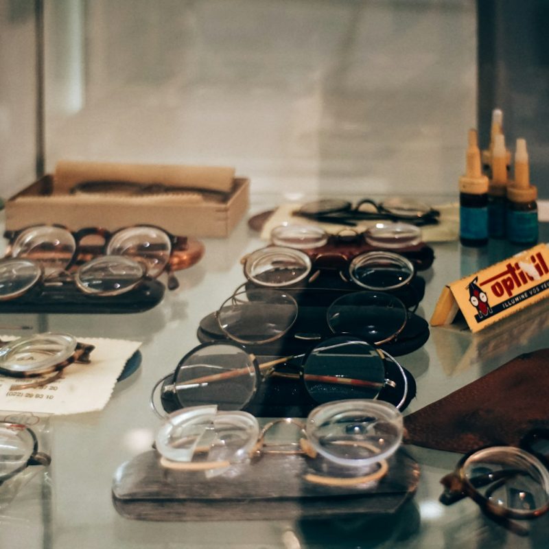 Assortment of vintage eyeglasses displayed in a shop.